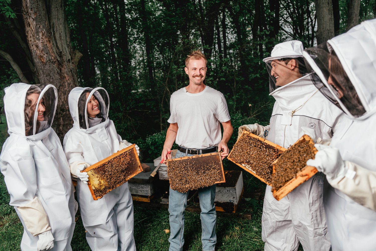 Three people in bee keeper gear